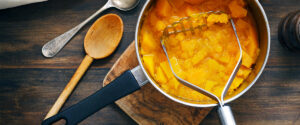 Cooking with cubed pumpkin in a pot in a kitchen